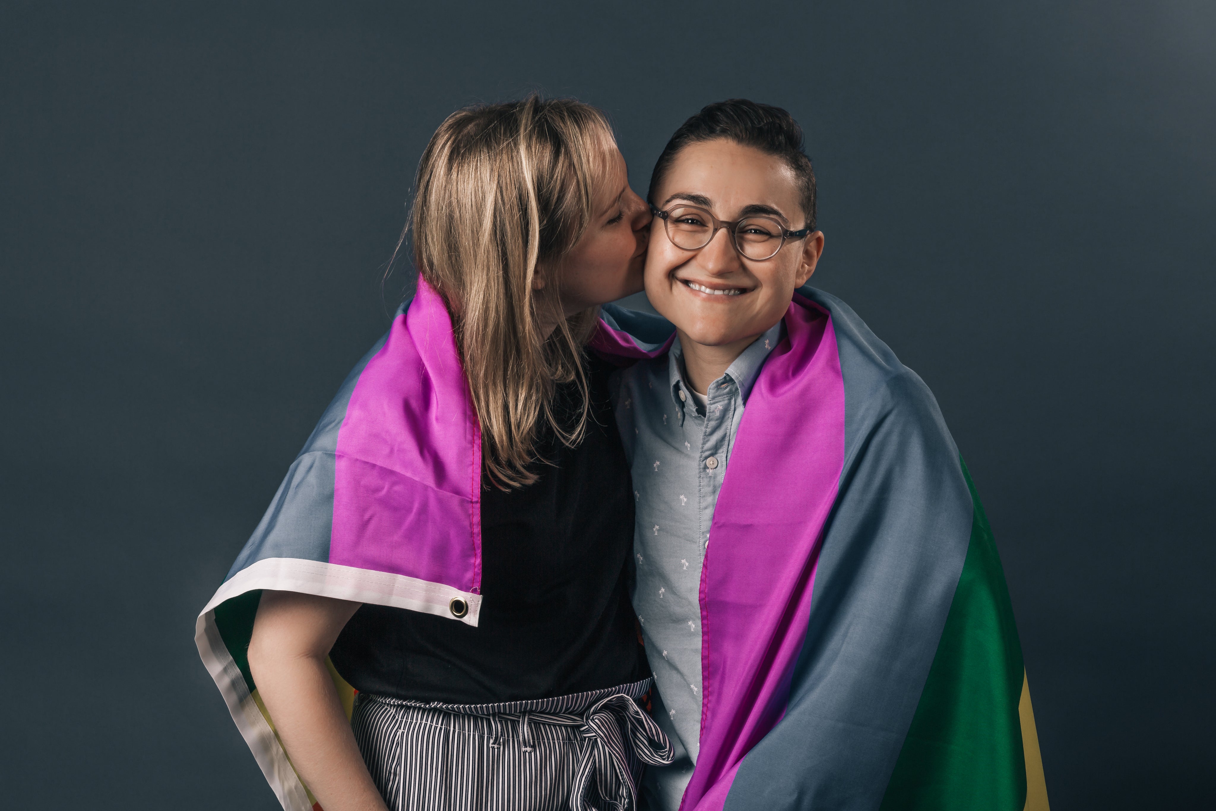 files/couple-wrapped-in-pride-flag-kiss.jpg